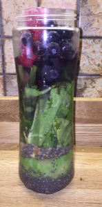Chia seeds (pre-soaked), half an avocado, big spoon of organic 100% peanut butter, fresh spinach, some diced celery, a cube of frozen spinach, handful of frozen blueberries & raspberries then filled with water